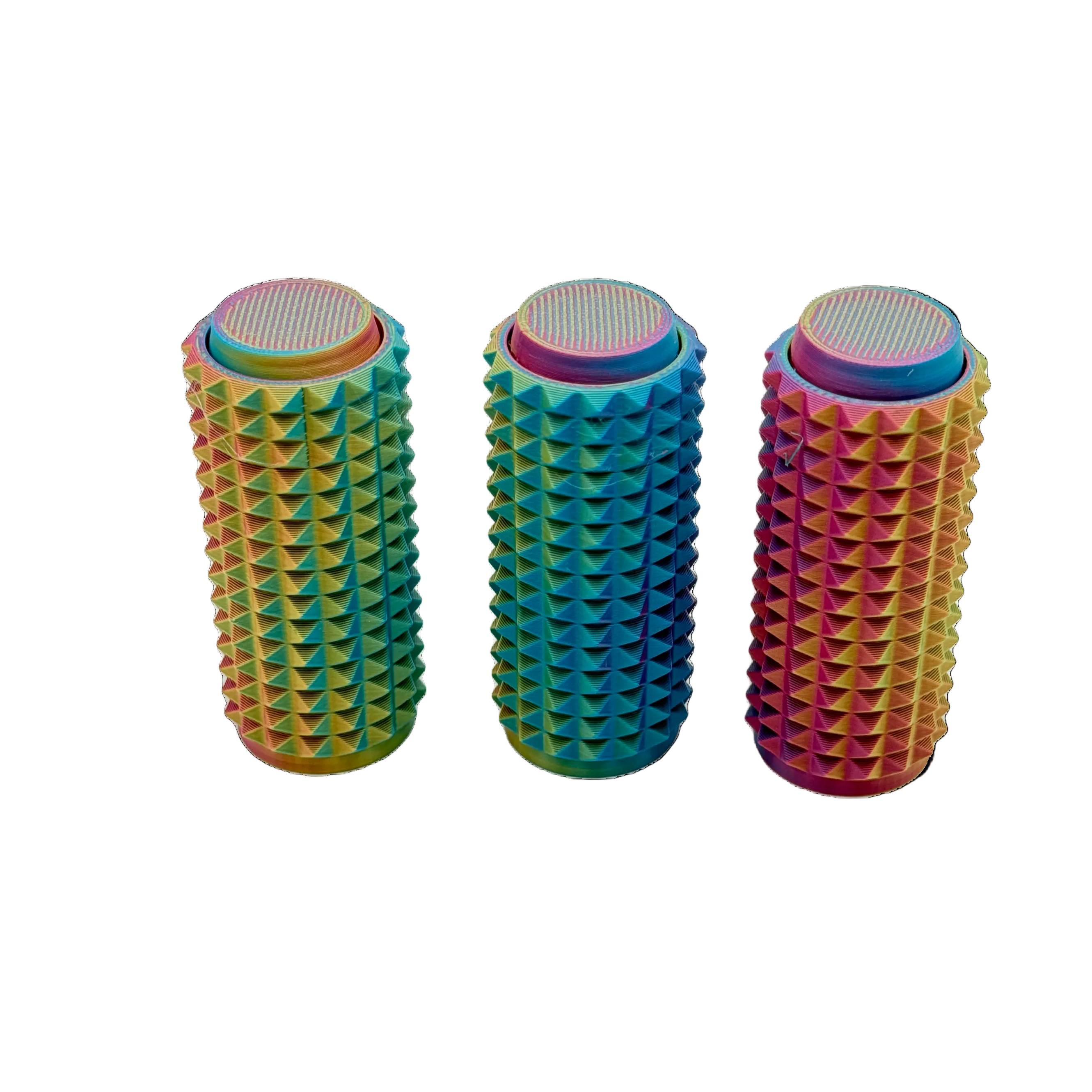 Three colorful cylindrical objects with textured surfaces on a white background